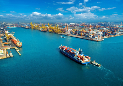 Aerial view of cargo ship and cargo container in harbor.