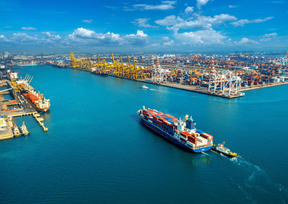 Aerial view of cargo ship and cargo container in harbor.